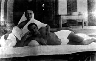 Sri Sri Thakur Anukulchandra lying with his head in the lap of his mother, Manomohini Devi